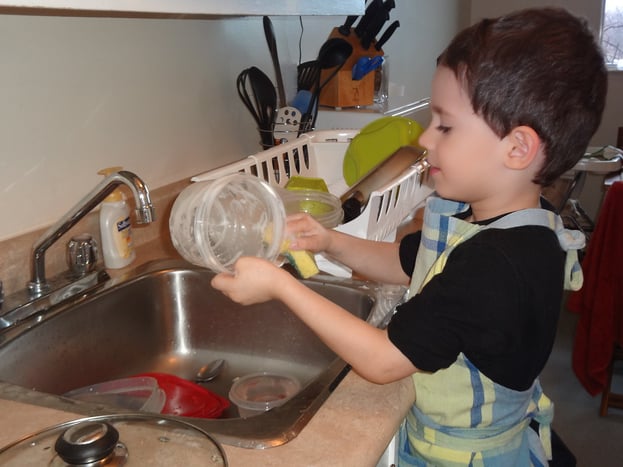 Child washing dishes